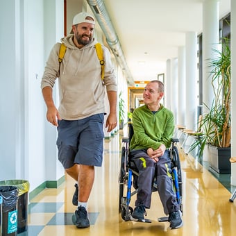 Caretaker and patient walking down the hallway