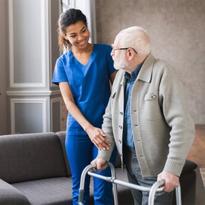 Healthcare worker and patient with walker