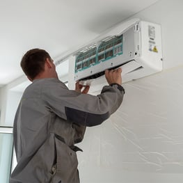 HVAC unit being installed onto wall